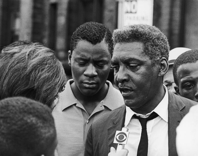 African-American civil rights activist Bayard Rustin (1912 - 1987) talks to a reporter during the Harlem Riots in Manhattan, July 23, 1964.
